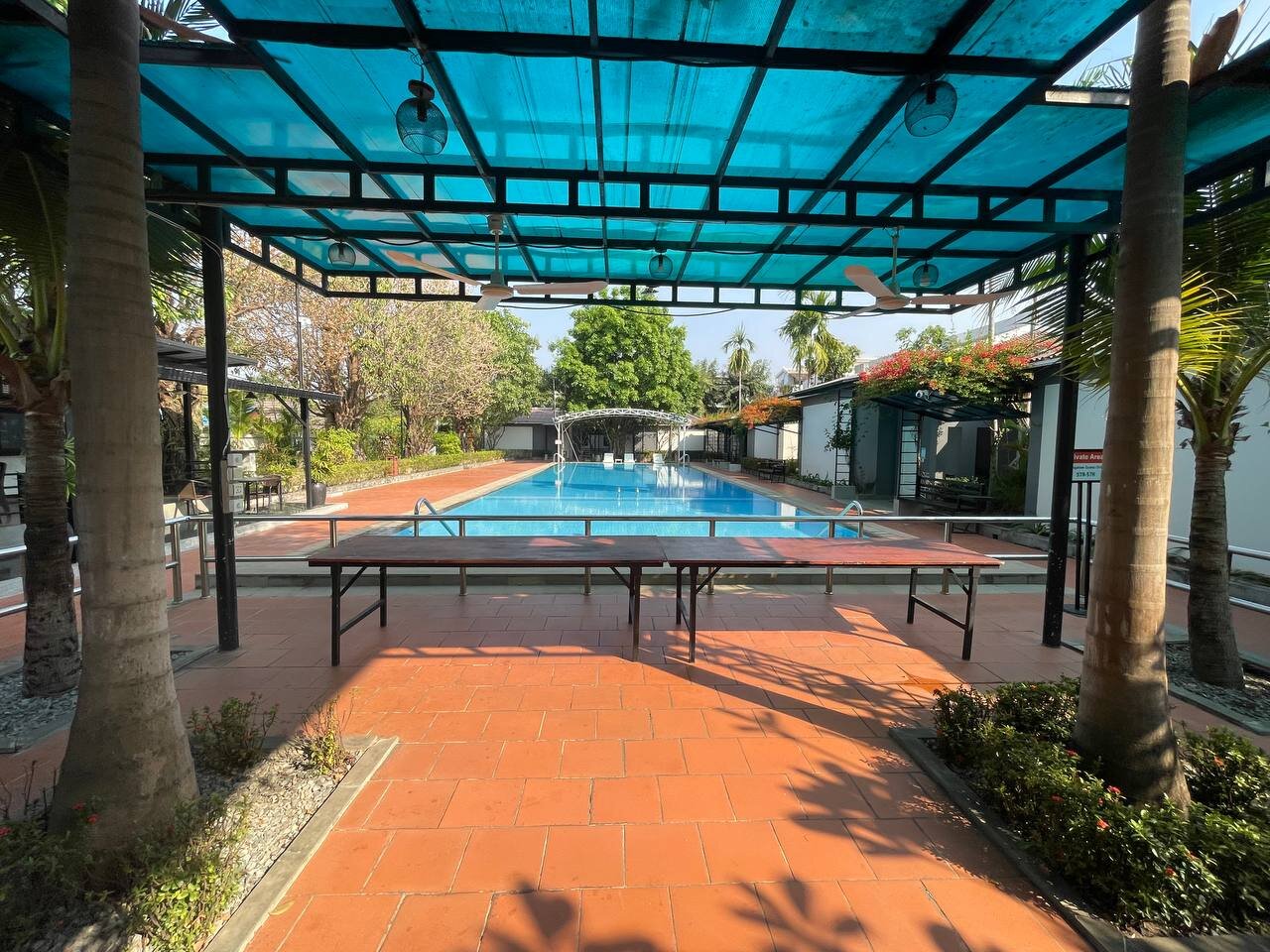 Covered poolside pavilion and shaded seating area